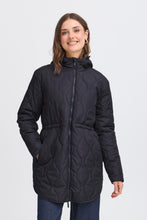 Load image into Gallery viewer, Woman wearing a black quilted jacket on a white background