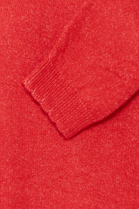Close-up of a red sweater with a beveled cuff Detail